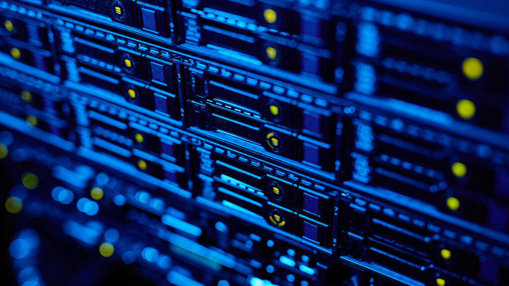 Blue-lit network server rack with indicator lights, representing telecommunications infrastructure and data connectivity.
