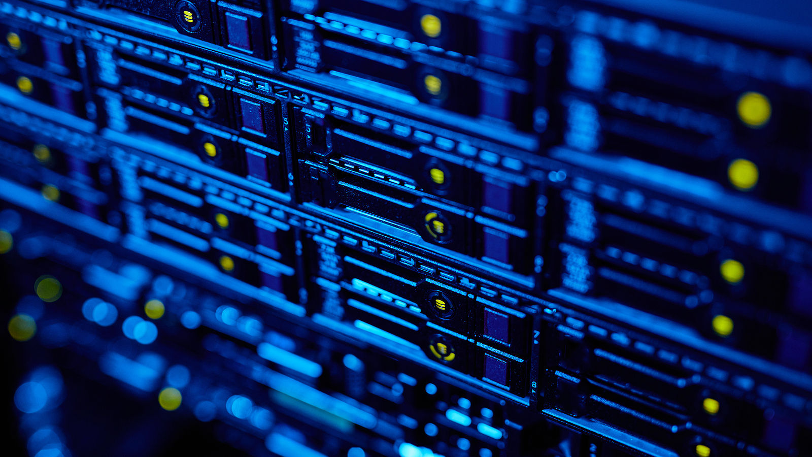 Blue-lit network server rack with indicator lights, representing telecommunications infrastructure and data connectivity.