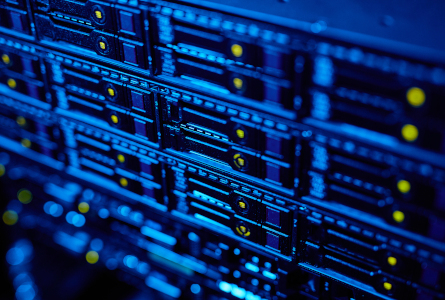 Blue-lit network server rack with indicator lights, representing telecommunications infrastructure and data connectivity.